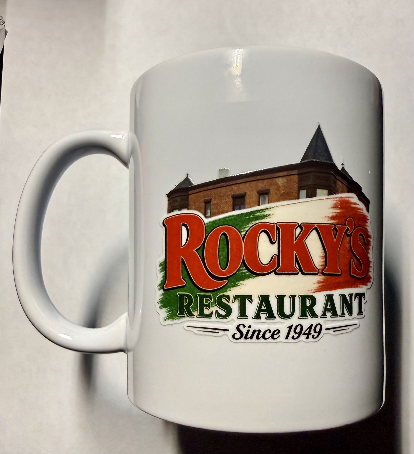 Rocky's Restaurant logo printed on a white mug